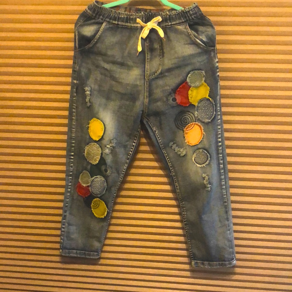 Denim jeans. Distressed pockets at the back.